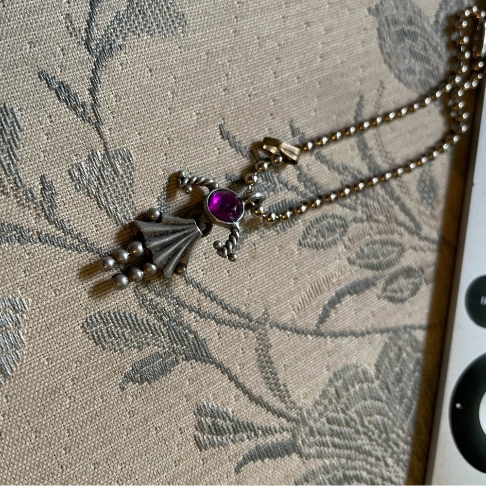 Charm with a pink stone